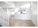 Inviting home foyer with tiled flooring, open staircase, and neutral walls at 20217 W Desert Bloom St, Buckeye, AZ 85326