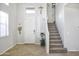 Bright and inviting home foyer features a staircase to the second level at 20217 W Desert Bloom St, Buckeye, AZ 85326