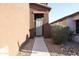 Entrance with a storm door, a walkway, and desert landscaping at 20217 W Desert Bloom St, Buckeye, AZ 85326