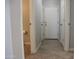 Hallway view highlighting the tile flooring and entry to a bathroom at 20217 W Desert Bloom St, Buckeye, AZ 85326