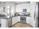 Bright kitchen featuring white cabinets, stainless steel appliances and a kitchen island at 20217 W Desert Bloom St, Buckeye, AZ 85326