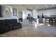 Open-concept living area with tile flooring that flows into the kitchen and dining area at 20217 W Desert Bloom St, Buckeye, AZ 85326