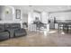 Open concept living room view shows tile floors, kitchen bar, and office space at 20217 W Desert Bloom St, Buckeye, AZ 85326