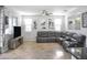Spacious living room shows tile floor, ceiling fan, and a large sectional sofa at 20217 W Desert Bloom St, Buckeye, AZ 85326