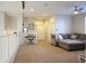 Spacious loft area with a sectional couch and carpeted floor at 20217 W Desert Bloom St, Buckeye, AZ 85326