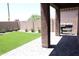 Covered patio with artificial turf and a built in barbeque at 20217 W Desert Bloom St, Buckeye, AZ 85326