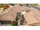 Aerial view of a single-story home showcasing its well-maintained roof, circular tower, and lush landscaping at 20532 W Summit Pl, Buckeye, AZ 85396
