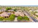Beautiful aerial view of a home with a tile roof in a lush, green community with solar panels on nearby homes at 20532 W Summit Pl, Buckeye, AZ 85396