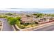 Suburban aerial shot showing the property nestled among well-maintained homes and lush green landscaping with mountain views at 20532 W Summit Pl, Buckeye, AZ 85396
