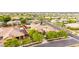 Gorgeous aerial view of a house with a tile roof nestled in a green, Gathering-friendly neighborhood with solar panels at 20532 W Summit Pl, Buckeye, AZ 85396