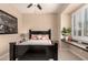 This bedroom has a ceiling fan and plantation shutters to control the light in the room at 20532 W Summit Pl, Buckeye, AZ 85396