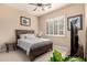 Bedroom featuring ceiling fan, tiled floors, and plantation shutters for controlling natural light at 20532 W Summit Pl, Buckeye, AZ 85396