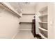 Walk-in closet with built-in shelving and storage options, offering ample space for organization at 20532 W Summit Pl, Buckeye, AZ 85396