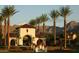 Gorgeous community gatehouse framed by palm trees with mountains in the background at 20532 W Summit Pl, Buckeye, AZ 85396