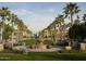 Picturesque community park with fountain, benches, and palm trees, perfect for leisurely strolls at 20532 W Summit Pl, Buckeye, AZ 85396