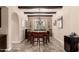 Formal dining room with a large table, seating for eight, designer light fixture, and light-filled windows at 20532 W Summit Pl, Buckeye, AZ 85396