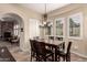 The dining room showcases a stylish chandelier, shuttered windows, and comfortable seating for six at 20532 W Summit Pl, Buckeye, AZ 85396