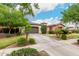 Well-manicured front yard leads to this single-Gathering home with lush landscaping, mature shade trees, and a private gated entry at 20532 W Summit Pl, Buckeye, AZ 85396