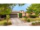 Charming single-Gathering home with a well-manicured lawn, mature trees, a circular tower feature, and a private driveway at 20532 W Summit Pl, Buckeye, AZ 85396