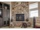Close-up on the stone fireplace with decorative accents and custom built-in media center at 20532 W Summit Pl, Buckeye, AZ 85396