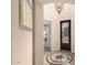 Inviting home foyer with tile floors, elegant light fixture, and a decorative medallion inset into the flooring at 20532 W Summit Pl, Buckeye, AZ 85396
