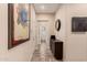 Hallway with tile floors, plenty of natural light and decor to give it a homey feel at 20532 W Summit Pl, Buckeye, AZ 85396