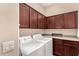 Laundry Room including washer, dryer, storage and counter space at 20532 W Summit Pl, Buckeye, AZ 85396