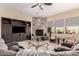 Comfortable living room features a stone fireplace, built-in media center, and large sofas for relaxing and entertaining at 20532 W Summit Pl, Buckeye, AZ 85396