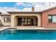 Relaxing pool view featuring covered outdoor dining and seating area, blending indoor and outdoor living spaces at 20532 W Summit Pl, Buckeye, AZ 85396