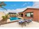 Inviting backyard oasis with a sparkling pool, outdoor kitchen, and lounge chairs, perfect for relaxing and entertaining at 20532 W Summit Pl, Buckeye, AZ 85396