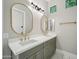 Bright bathroom featuring double sink vanity with modern gold fixtures, stylish mirrors, and a sleek design at 210 E Cactus Wren Dr, Phoenix, AZ 85020