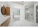 Bright primary bathroom with a modern tub, glass shower, wooden cabinets, and dual sinks at 210 E Cactus Wren Dr, Phoenix, AZ 85020