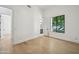 Neutral bedroom with light hardwood floors and a large window offering backyard views at 210 E Cactus Wren Dr, Phoenix, AZ 85020