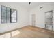 Sun-filled bedroom featuring hardwood floors, large window, and neutral paint at 210 E Cactus Wren Dr, Phoenix, AZ 85020