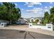 Beautiful single-story home with mature trees and a well-manicured lawn in a suburban neighborhood at 210 E Cactus Wren Dr, Phoenix, AZ 85020