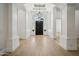 Grand foyer with soaring ceilings, hardwood floors, and an ornate chandelier hanging above at 210 E Cactus Wren Dr, Phoenix, AZ 85020