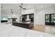 Modern kitchen featuring a spacious center island with bar seating, and view of living spaces at 210 E Cactus Wren Dr, Phoenix, AZ 85020