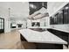 Elegant kitchen featuring a modern island, stainless steel appliances, and an open layout to the living area at 210 E Cactus Wren Dr, Phoenix, AZ 85020