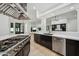 Well-equipped kitchen with stainless steel appliances, a center island, and views of the open-concept living spaces at 210 E Cactus Wren Dr, Phoenix, AZ 85020