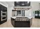 Gourmet kitchen with stainless steel appliances, a center island with a cooktop, and stylish cabinetry at 210 E Cactus Wren Dr, Phoenix, AZ 85020