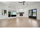 Bright living room with hardwood floors, fireplace, built-in shelving, and backyard access at 210 E Cactus Wren Dr, Phoenix, AZ 85020