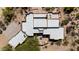 An aerial view reveals the unique architecture and roofline of this southwestern-style home with desert landscaping at 22050 N 90Th St, Scottsdale, AZ 85255