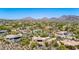 Aerial shot featuring a luxurious desert home with stunning mountain views, blending architectural beauty and nature at 22050 N 90Th St, Scottsdale, AZ 85255