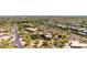 A stunning aerial shot showcases a southwestern home nestled in the desert with lush vegetation and mature landscaping at 22050 N 90Th St, Scottsdale, AZ 85255