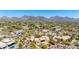 A panoramic aerial view shows a beautiful home with lush desert landscaping and picturesque mountain range backdrop at 22050 N 90Th St, Scottsdale, AZ 85255