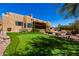 Spacious backyard showcasing a putting green, desert landscaping, and an inviting outdoor space at 22050 N 90Th St, Scottsdale, AZ 85255