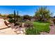 Inviting backyard with flagstone patio, built-in spa, desert landscaping, and a putting green at 22050 N 90Th St, Scottsdale, AZ 85255