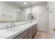 Bright bathroom with a double sink vanity, white tile countertops, and ample cabinet storage at 22050 N 90Th St, Scottsdale, AZ 85255