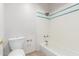 Clean bathroom featuring a tiled shower/tub combination and a modern toilet at 22050 N 90Th St, Scottsdale, AZ 85255