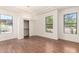 Spacious bedroom with hardwood floors, abundant light, and tray ceiling at 22050 N 90Th St, Scottsdale, AZ 85255